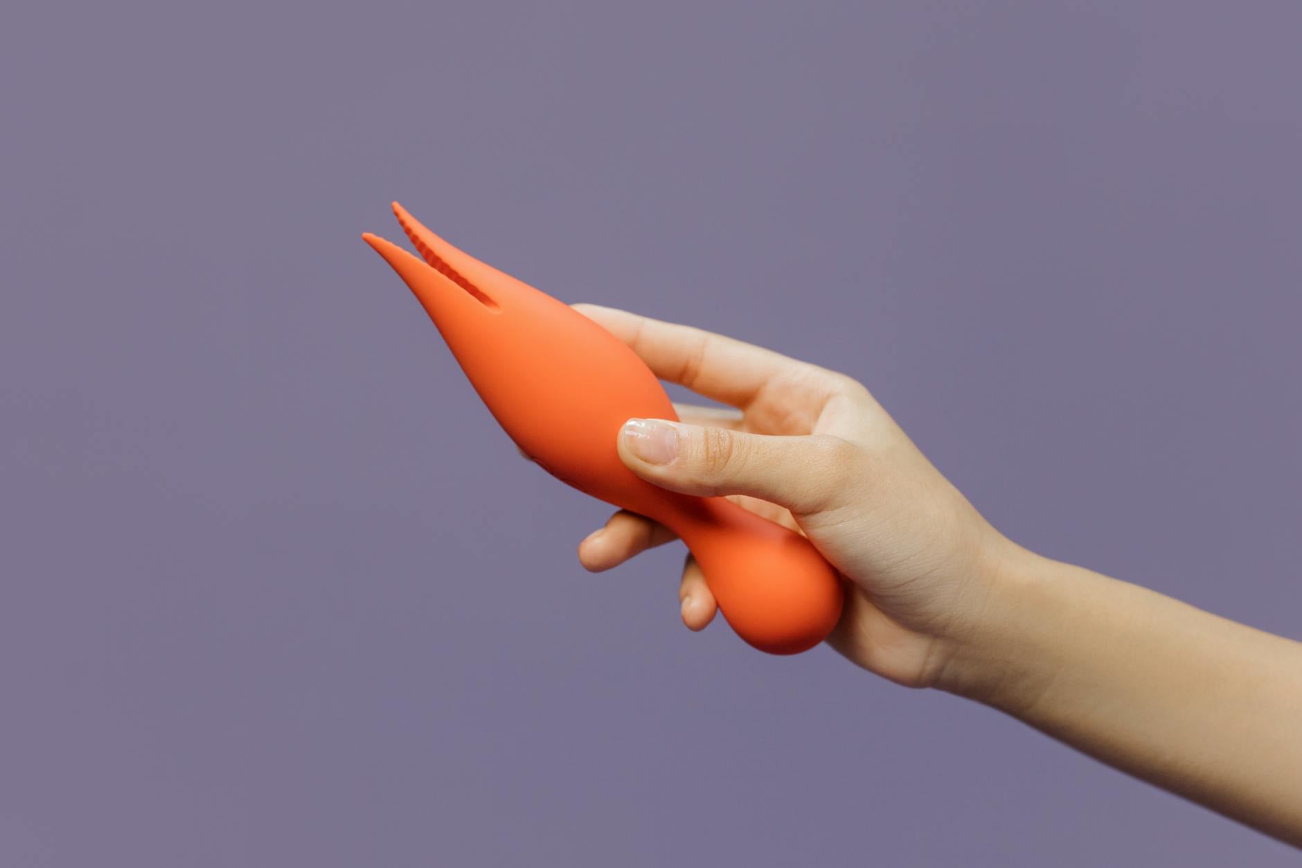 A yellow silicone vibrator surrounded by peeled bananas on a bright yellow background, symbolizing the modern design of lemon vibrators.