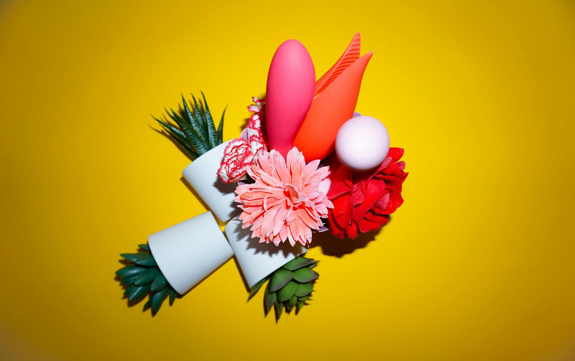 A hand holding a lemon against a vivid yellow background, conveying freshness and arousal potential