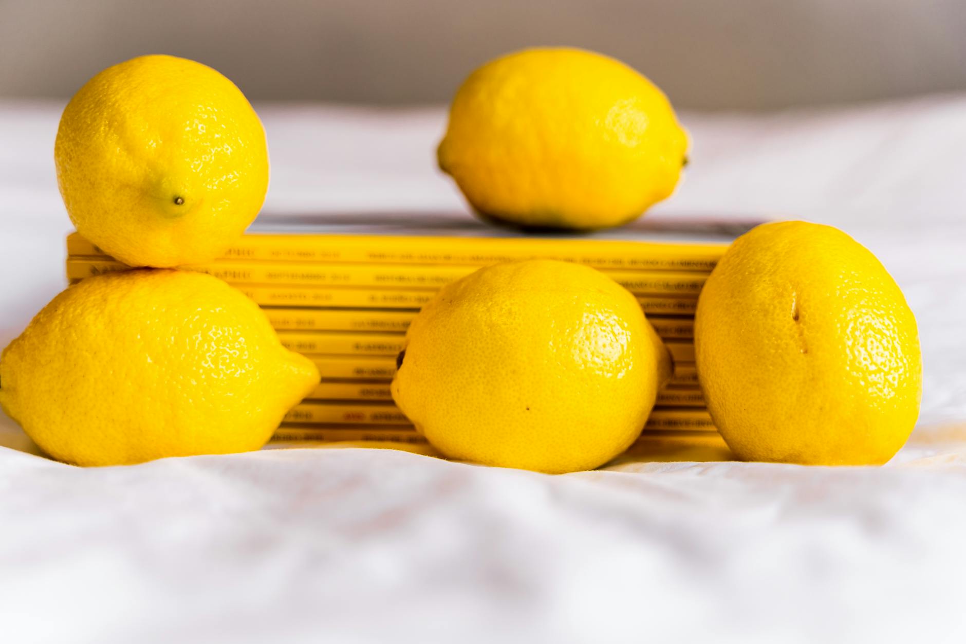 Bright yellow lemons on a vivid yellow background, symbolizing renewed pleasure and vitality